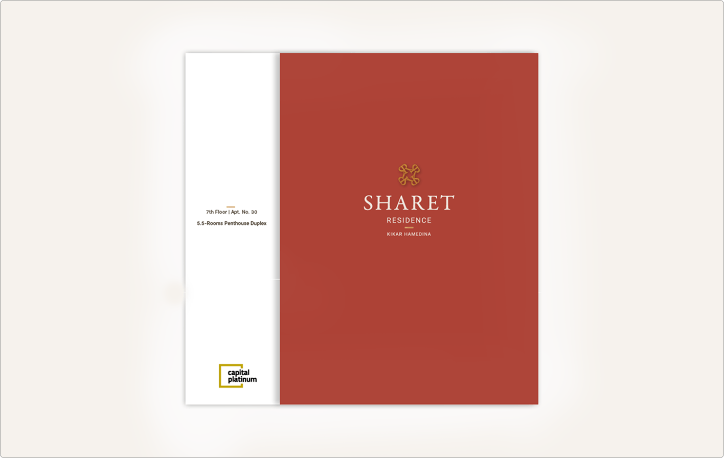 כריכת חוברת אדומה עם הכיתוב "SHARET RESIDENCE" בצבע זהב; בצד הלבן מופיעה הכתובת ולוגו צהוב בתחתית.